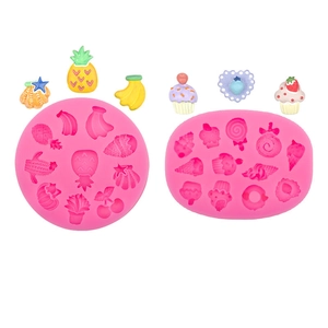Pink silicone mold set for candy and lollipops featuring pineapple and cupcake shapes
