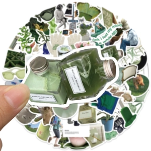 Close-up of a hand holding a green Matcha sticker from a 62-piece Korean ins style set