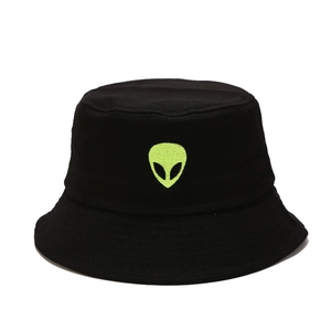 Close-up of neon green alien embroidery on black cotton canvas bucket hat