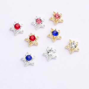 Detailed view of 8-piece star-shaped nail charms with colorful rhinestones on white base