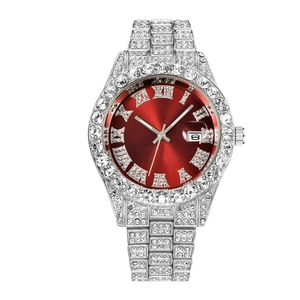 Macro detail of iced-out silver quartz watch featuring a sunburst red dial and date window