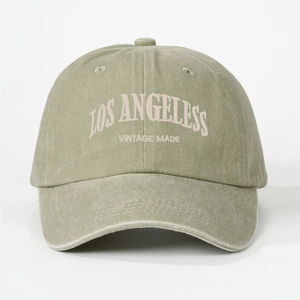 Close-up of Los Angeles embroidery on vintage washed olive green baseball cap
