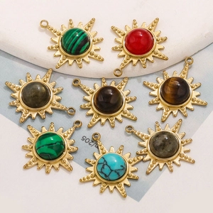 Set of 8 gold sun-shaped pendants with tiger eye and natural stones on a stone display