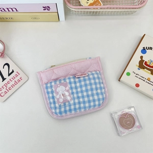 Close-up of pink quilted card holder with blue gingham pattern and clear window slot