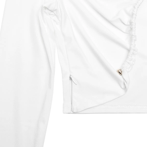Close-up of white crop top with side invisible zipper and gold metal decor on pleats