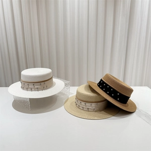 Three elegant flat-top straw hats with rhinestone-studded ribbons in white and beige tones