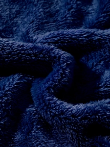 Macro shot of deep blue double-sided fleece fabric texture for thick winter jackets