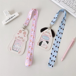 Detail view of pink rabbit and blue puppy PU leather card holders with lanyards