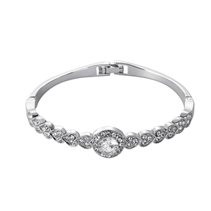 Macro shot of silver heart-shaped alloy bracelet featuring round crystal and pavé stones