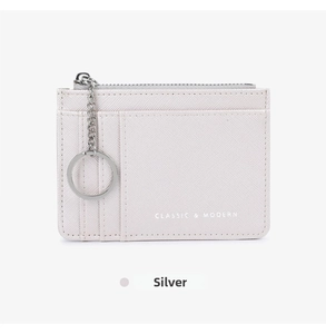Detailed view of silver cross-grain leather wallet with card slots and key chain