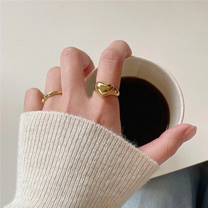 Retro 925 sterling silver gold heart ring set worn by model holding a coffee cup