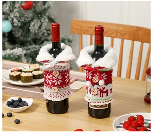 Detail of Christmas wine bottle covers with snowflake and reindeer knit patterns