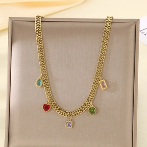 Detail of gold woven necklace featuring five colorful teardrop and heart-shaped gemstones