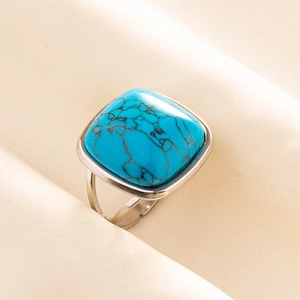 Macro shot of vintage silver ring with square blue turquoise and adjustable band