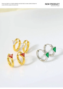 Macro shot of geometric triangle zircon earrings in gold and silver luxury finishes