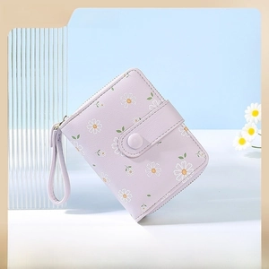 Detail of lavender PU leather short wallet with white daisy print and wrist strap