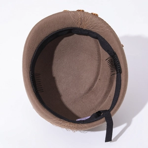 Detail of wool felt hat interior with size tag M 57CM and built-in fixing hair clips