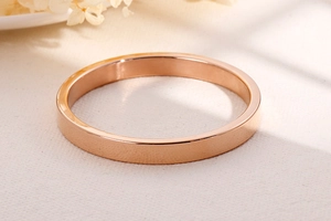Macro shot of polished rose gold stainless steel bangle with smooth reflective finish