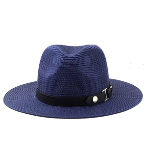 Close-up of navy straw fedora hat with black leather band and gold metal buckle detail