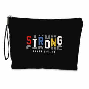 Detail of waterproof linen bag featuring colorful 'STRONG' print and a black wristlet strap