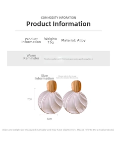 Detail view of large round textured earrings with size 7x5cm and 15g weight specs