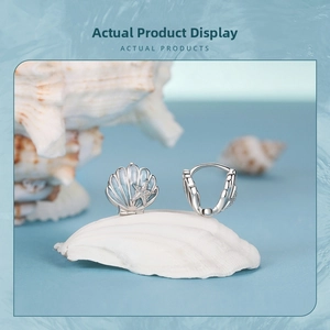 Detailed close-up of s925 silver shell earrings with blue starfish ocean design