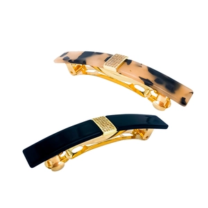 Detail of tortoise shell and black acetate hair clips with crystal rhinestone bands