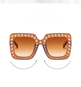 Detail of square sunglasses bridge with sparkling crystals and brown gradient frame