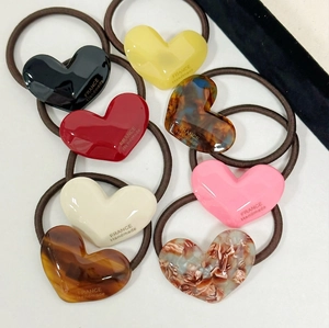 Set of 8 heart shaped acetate hair ties in various colors and marble patterns