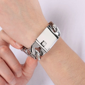 Detailed view of silver thick Cuban link bracelet with rectangle clasp worn on wrist