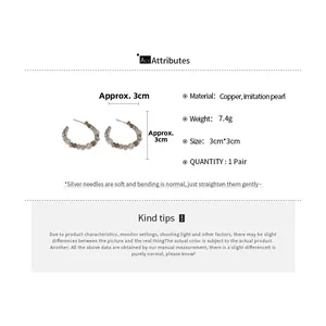 Detail of 3cm gold-plated hoop earrings featuring elegant white imitation pearls and metal beads