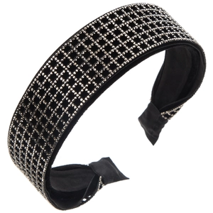 Macro shot of silver rhinestone grid pattern on wide black velvet padded headband