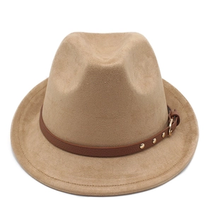Detail of camel suede fedora featuring a brown leather strap with gold rivets and buckle
