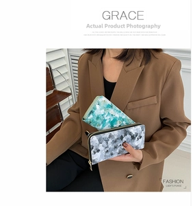 Detail of floral and marble print long wallets with premium metal zipper closure