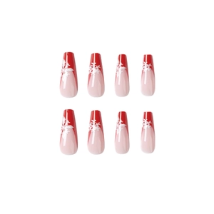 Red French tip press-on nails with white snowflake patterns and glossy finish