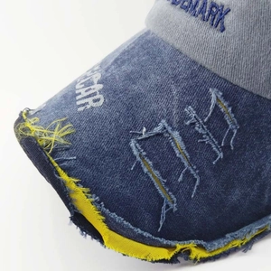 Distressed navy washed denim baseball cap with frayed edges and vintage embroidery