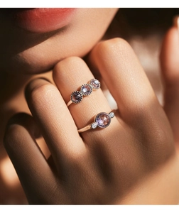 Macro detail of S925 sterling silver rings featuring purple gems and intricate beadwork