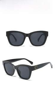 Detailed side and front view of black square sunglasses with golden heart metal icon