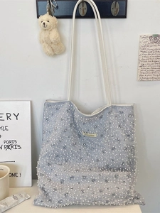 Light blue pearl mesh tote bag with white floral netting and plush bear pendant detail