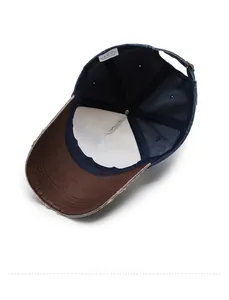 Internal view of denim baseball cap showing metal buckle and care label details