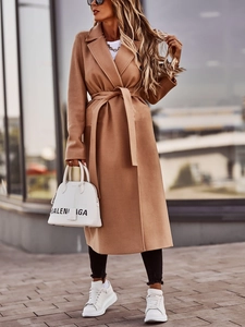 Detailed view of the camel wool coat featuring a stylish waist tie and wide lapel collar