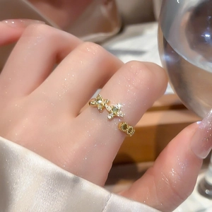 Detail of 18k gold plated ring featuring three sparkling zircon butterflies on hand