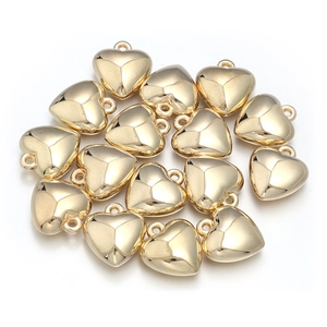 Close-up of polished gold heart-shaped CCB beads for DIY jewelry making and crafts