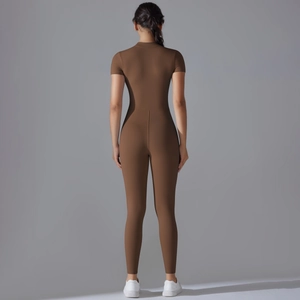 Back view of brown short sleeve yoga jumpsuit featuring high elastic slim fit fabric