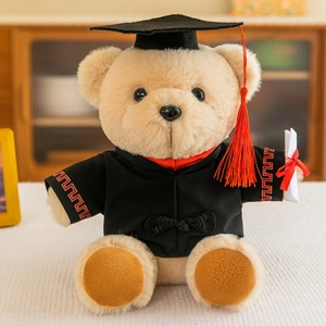 Plush graduation teddy bear wearing a black gown and mortarboard holding a diploma