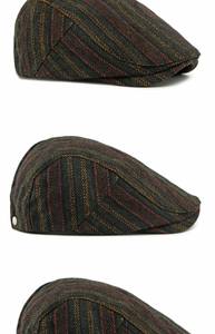 Detail of green herringbone tweed flat cap showing thick wool texture and vintage pattern