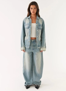 Full view of light blue washed denim jacket and wide-leg high waist jeans set