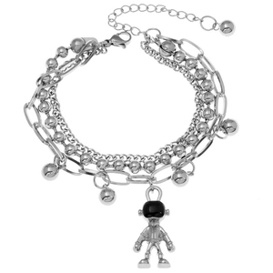 Detail of layered stainless steel bracelet featuring astronaut charm and bead chain