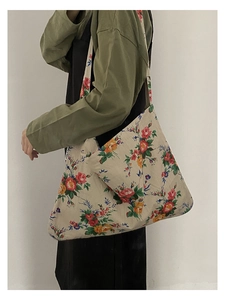 Detail of floral canvas tote bag showing vintage pattern on model's shoulder