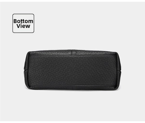 Detailed bottom view of large black tote bag featuring premium pebble grain leather texture